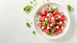 © MinimalZine - A fresh and vibrant watermelon feta salad garnished with basil leaves, capturing the essence of summer in a minimalist design.