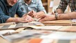 © AbiScene - Design Dreams Couple Envisioning Home Renovations with Real Estate Agent Hands and Samples