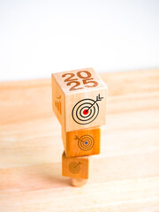 Poster - 2025 business expansion goal and success banner concept. 2025 year numbers with target icon on wooden cube blocks stacked from big to small size on white vertical background. Happy New Year in 2025.
