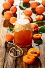 Wall Mural - Apricot jam and fresh fruit on an old wooden table.