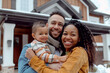 © Renata Hamuda - Portrait of Happy multiracial family standing in front of their new house