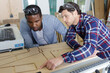 © auremar - woodworkers holding pieces of wood