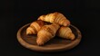 © Milos Vucicevic - Artistically arranged croissants on a dark wooden platter, showcasing their golden glow and exquisite texture