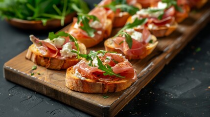 Wall Mural - Gourmet bruschetta topped with prosciutto, cheese, and arugula on a rustic wooden board, close-up