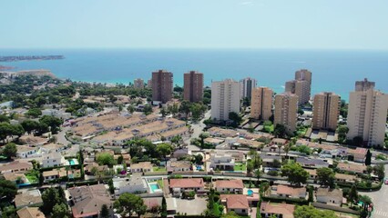 Canvas Print - Aerial drone point of view spanish tourists resort village townscape of Dehesa de Campoamor during sunny summer day, view to the harbor, coastal skyscrapers and Mediterranean Sea. Costa Blanca. Spain