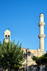 Sticker - Orthodox church with a bell tower and a minaret in the town of Chania on the island of Crete