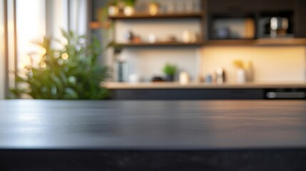 Dark kitchen countertop with a blurred background of a bright, modern kitchen, featuring plants, shelves, and warm lighting, creating a cozy atmosphere