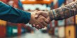 © Putra - Handshake Agreement Between Two Workers in Industrial Container Yard