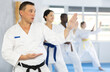 © JackF - Group of multiethnic karate people practicing karate technique in gym