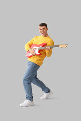 Poster - Cool young man playing electric guitar on light background