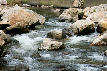 water flows over the rocks in a river in the mountains, the waitawheta river