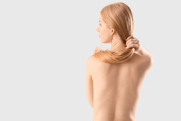 Wall Mural - Beautiful young woman with naked back on white background