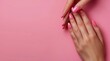 © olegganko - Female Hand With Pink Nail Polish on Pink Background