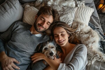 Wall Mural - Photo of a young couple and a dog lying on a living room sofa, top view. The woman had curly red hair and the man was wearing a blue denim shirt
