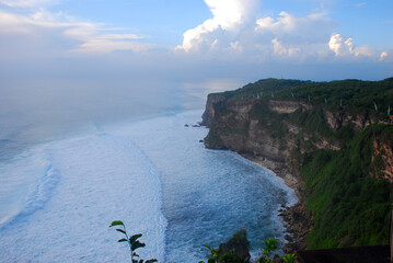 Wall Mural - Turquoise ocean sea water white wave splashing deep blue sea. Bird eye view monster wave splash on rock. Tropical sea beach in summer seaside outdoor. Ocean island beautiful dramatic landscape.