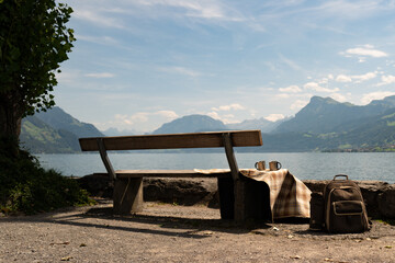 Wall Mural - Travel in the mountains. Tourism in Alps lake and mountains. Tourism concept. Hiking backpack near nature of Switzerland. Switzerland landscape. Camping and trekking equipment.