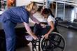 © Wavebreak Media - Female therapist assisting girl with cerebral palsy in wheelchair, rehabilitation therapy session