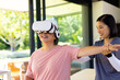 © Wavebreak Media - Senior woman using VR headset for physical therapy, guided by female therapist