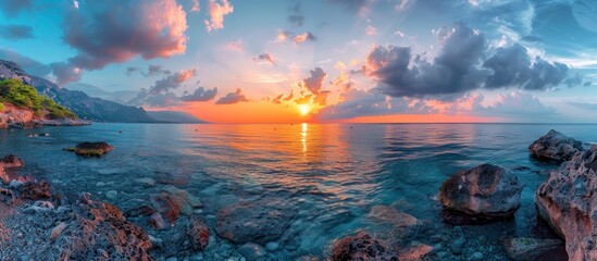 Poster - Peaceful seascape at sunset with vibrant colors reflecting on the ocean water.  Sky filled with colorful clouds.