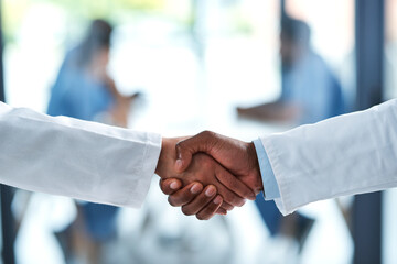 Wall Mural - People, medical and doctor handshake in hospital, medicine and wellness with healthcare professional. Trust, support and shaking hands for partnership or clinic collaboration, thank you and welcome