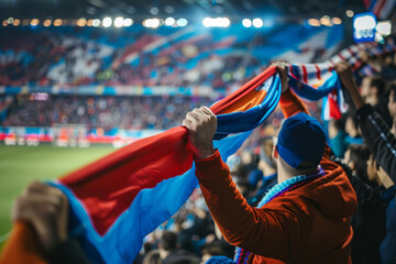 Wall Mural - Fan's hands holding soccer scarf high in stadium, unity symbol