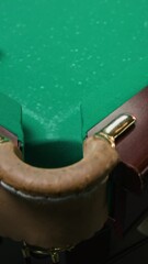 Wall Mural - Vertical slowmo closeup of white billiard ball falling into hole on green pool table during game