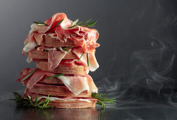 Wall Mural - Italian prosciutto or Spanish jamon with bread and rosemary.