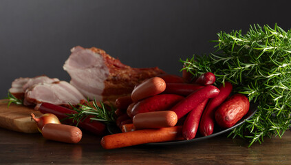 Wall Mural - Various sausages and smoked pork on a kitchen table.