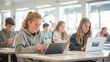 © Viktorikus - Teenage Students Engaged in Learning with Laptops in Classroom