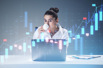 Aufkleber - Attractive thoughtful young businesswoman drinking coffee at desk with laptop and growing forex chart hologram on blurry background. Financial growth and trade concept. Double exposure.