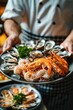 © Артур Комис - close up of a chef holding a bowl of seafood. Selective focus