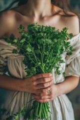 Canvas Print - close-up of a woman holding coriander in her hands. Selective focus