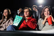 © makedonski2015 - Relaxed friends gathered to go to the cinema in the evening. Popcorn and drinks, comfortable chairs
