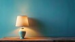 © Robert - Table lamp on wooden table with space on blue wall background