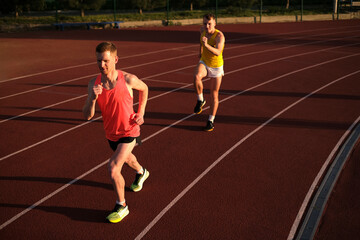 Athletes compete in running at the stadium