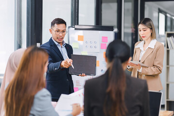 Wall Mural - Professional diverse business team presenting and discussing data charts and graphs during meeting in modern office.