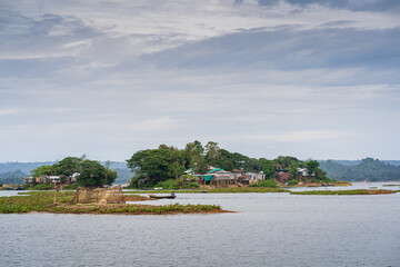 Wall Mural - Scenic landscape view of small picturesque islands on Kaptai lake under cloudy sky, Rangamati, Chittagong, Bangladesh