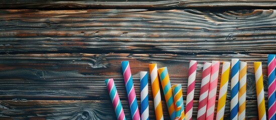Poster - Vibrant paper straws on a rustic wooden backdrop for events and parties with centered focus offering space for text or designs. Copy space image. Place for adding text and design