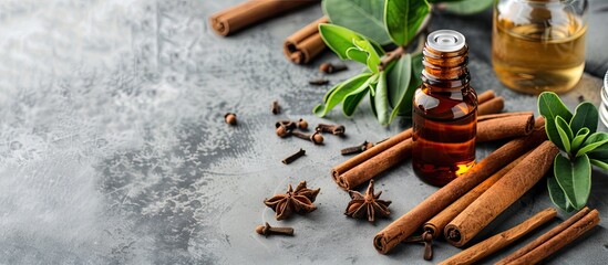 Fototapete - Cinnamon oil for various uses like cooking, aromatherapy, and skincare, displayed alongside cinnamon sticks on a grey backdrop with space for text in the image. Copy space image