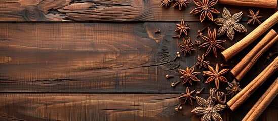 Poster - Wooden table adorned with aromatic cinnamon sticks and anise stars in a flat lay arrangement with available copy space image.