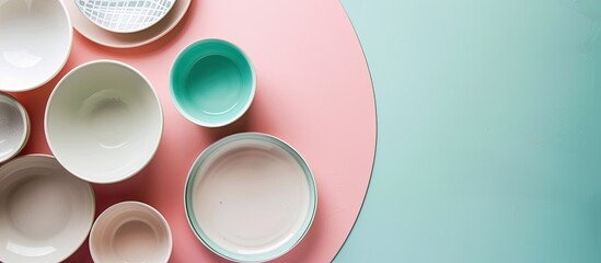 Poster - Modern white and blue ceramic tableware arranged on a pink and green background in a top-down view with ample space for text or imagery.