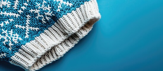 Poster - Scandinavian-style knitting pattern on a blue backdrop with copy space image.