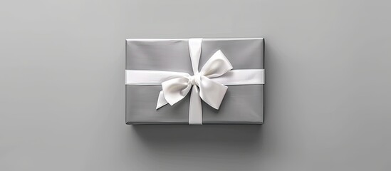 Aufkleber - Top view of gray gift box with a white bow and tag, set against a white background, ideal for copy space image.