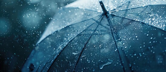 Wall Mural - Transparent umbrella with water droplets in rainy weather, featured in a copy space image.