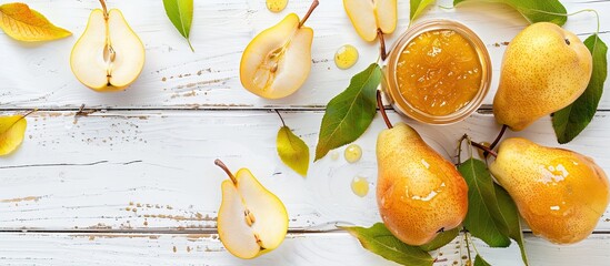 Poster - Golden homemade pear jam with farm-fresh pears and leaves on a white wooden backdrop for a versatile copy space image.