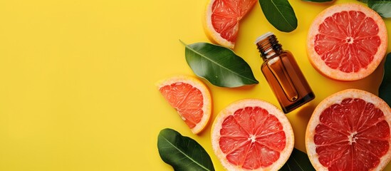 Aufkleber - Essential oil bottles and grapefruit slices on a vibrant yellow backdrop with copy space image.