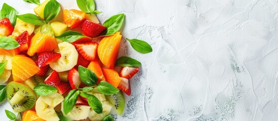 Poster - A fruit salad with green leaves displayed on a white backdrop to enhance vibrant colors in the copy space image.