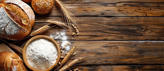 Poster - Wooden table with rustic bread, wheat ears, and white flour, all set up for display with a spacious copy space image.