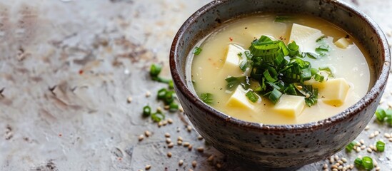 Poster - A flavorful cup of miso soup displayed on a plain white surface with ample copy space image.