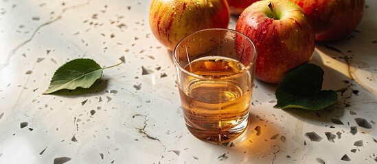 Poster - Apple cider displayed in a glass on a terrazzo countertop with a blank space for additional content in the image.